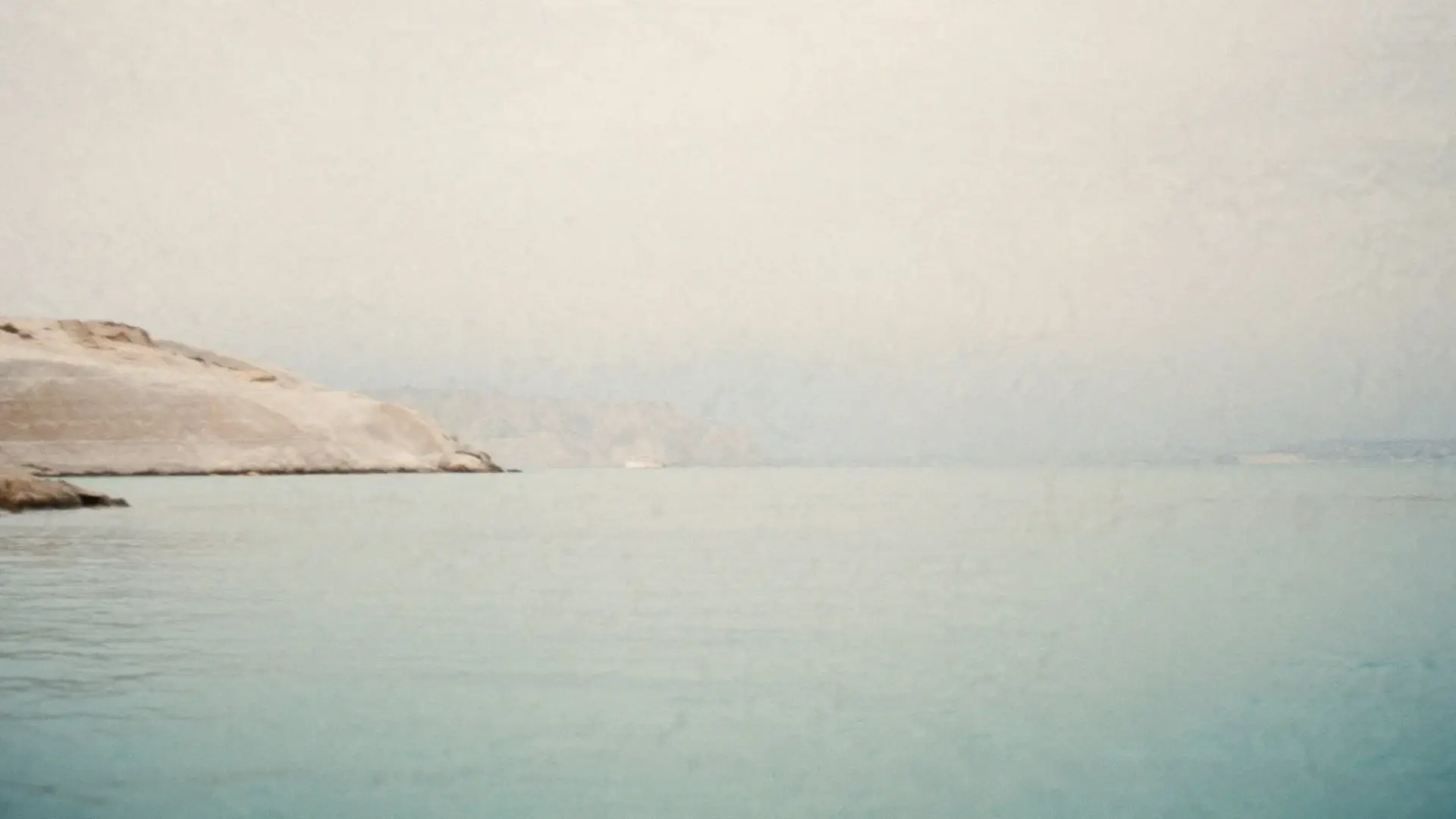 A calm pale sea off the west coast of Menorca